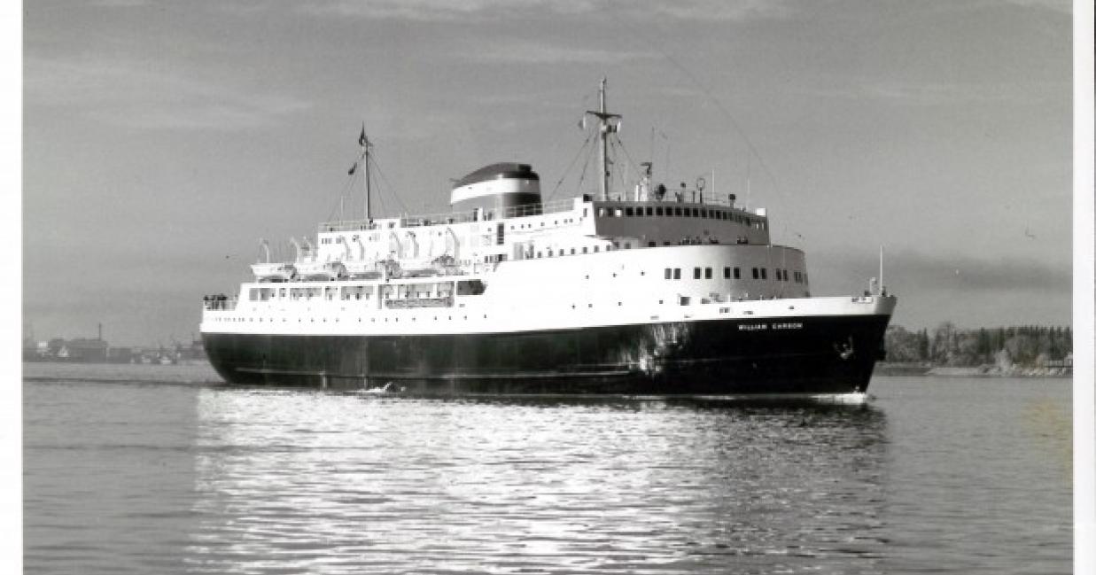 Side shot of the MV William Carson sailing away from the port