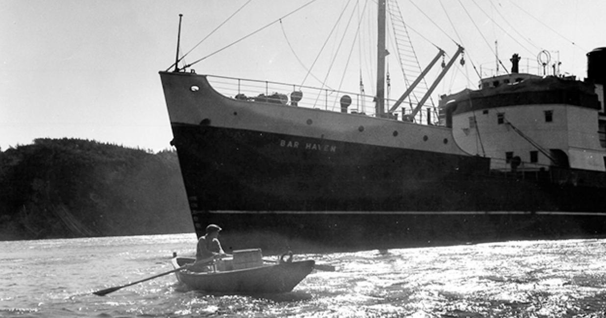 a man in a canoe rowing away from the ss bar haven