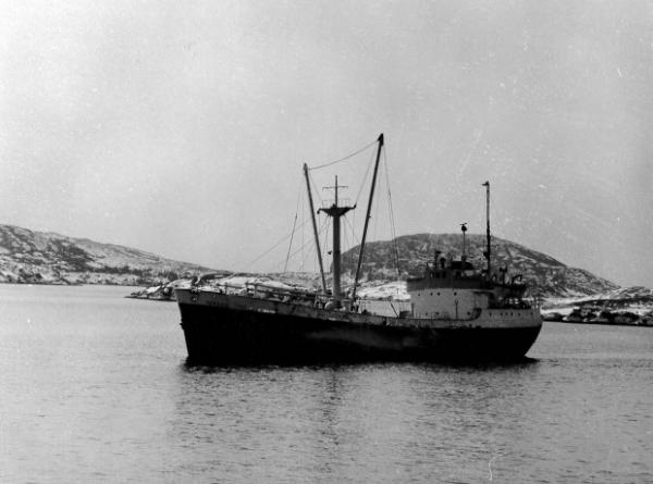 Image: black and white, small unidentifiable ship in the Port aux Basques harbour 
